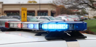 Close-up of a police car's emergency lights in a parking lot