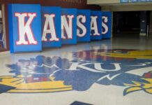 Kansas logo displayed on the floor of a sports venue