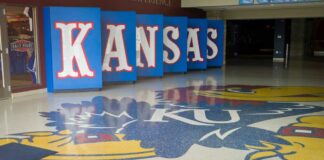 Kansas logo displayed on the floor of a sports venue