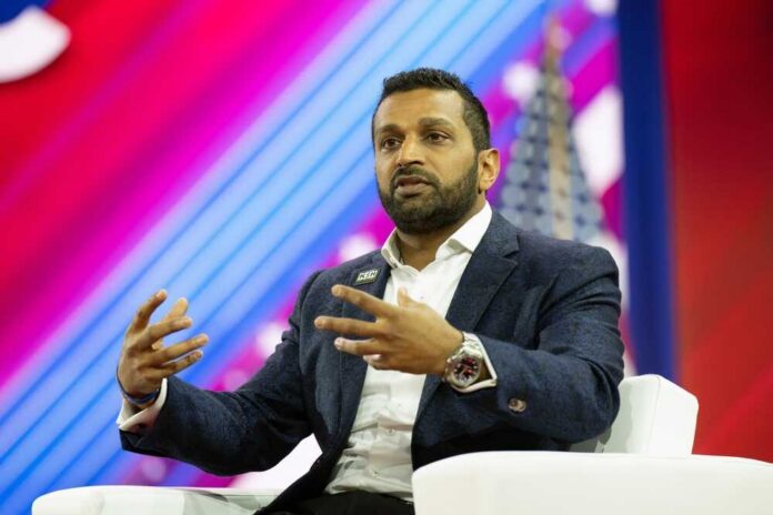 A speaker gesturing while discussing on stage at a conference