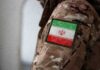 Close-up of a military uniform with an Iranian flag patch