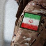 Close-up of a military uniform with an Iranian flag patch