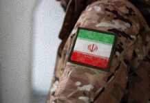 Close-up of a military uniform with an Iranian flag patch