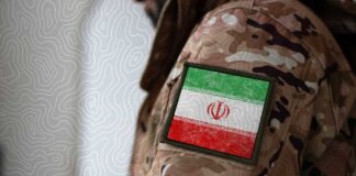 Close-up of a military uniform with an Iranian flag patch