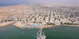 Aerial view of a coastal town with fishing boats and residential buildings