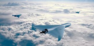 Three drones flying above the clouds in a clear sky