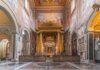 Pope Welcomes Anglicans – Catholics Demand Answers Interior view of a grand religious building with ornate frescoes and a central altar