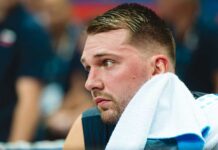 Lakers’ Title Hopes Crushed by Shocking Injury Close-up of a basketball player with a towel around his neck, looking focused