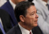 A man in a suit speaking during a government hearing