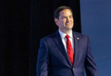 Democrats’ Shocking Plea: Go Easy On Narcos? Man in suit with red tie on stage