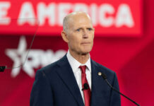 Wild Claims? Scott’s SAFE KIDS Bill Sparks Outrage Bald man in suit speaking at a podium