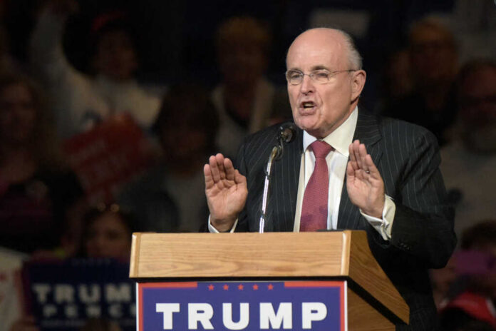 Man speaking at podium labeled Trump.