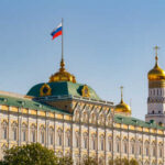 The Kremlin building with the Russian flag and golden domes in the background