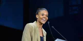 A woman speaking at a podium during a conference