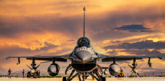 F-16 fighter jet on an airbase during sunset