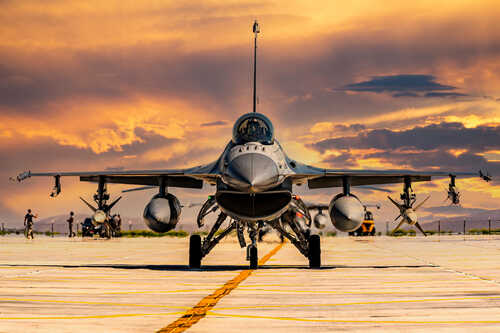 F16,Fighter,Jet,In,A,Taxiing,Position F-16 fighter jet on an airbase during sunset