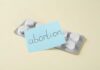 A pack of abortion pills with a sticky note labeled 'abortion'