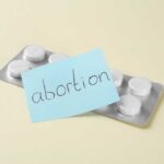 A pack of abortion pills with a sticky note labeled 'abortion'