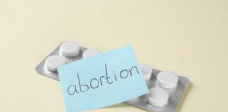 A pack of abortion pills with a sticky note labeled 'abortion'