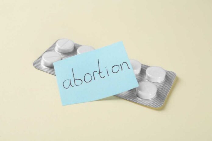 A pack of abortion pills with a sticky note labeled 'abortion'