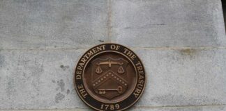 Bronze seal of the Department of the Treasury mounted on a stone wall