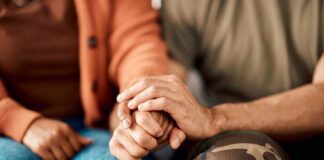 A couple holding hands, showcasing intimacy and support