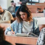 Students in a classroom engaged in studying and note-taking