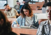 Students in a classroom engaged in studying and note-taking