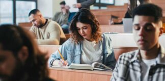 Students in a classroom engaged in studying and note-taking