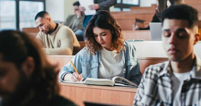 Students in a classroom engaged in studying and note-taking