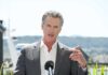 Gas Tax Rebellion: Newsom Ignores Voter Outrage A man in a suit speaking at a press conference outdoors
