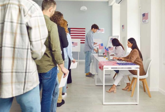 American,Voters,At,The,Polling,Station.,Group,Of,Young,People People waiting in line at a polling station to cast their votes