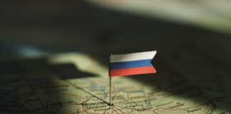 A small Russian flag pinned on a map of Moscow
