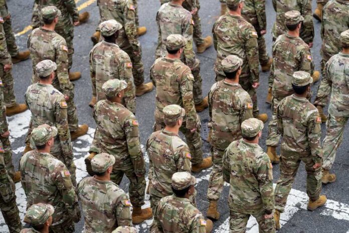 A formation of soldiers in military uniforms marching in a parade