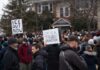 Crowd of protesters holding signs at a demonstration