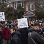 Crowd of protesters holding signs at a demonstration