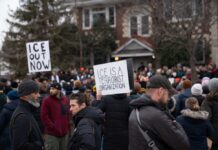 Crowd of protesters holding signs at a demonstration