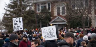 Crowd of protesters holding signs at a demonstration