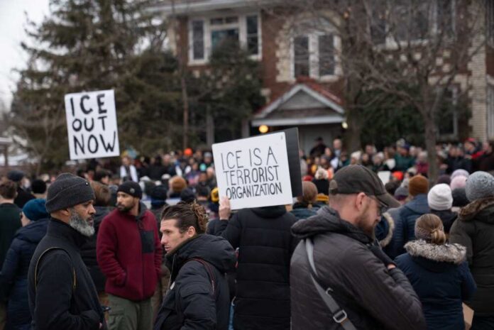 Crowd of protesters holding signs at a demonstration