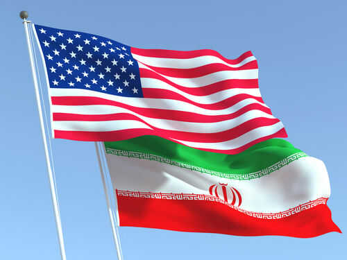 us-iran-1830257906 American and Iranian flags waving in the sky.