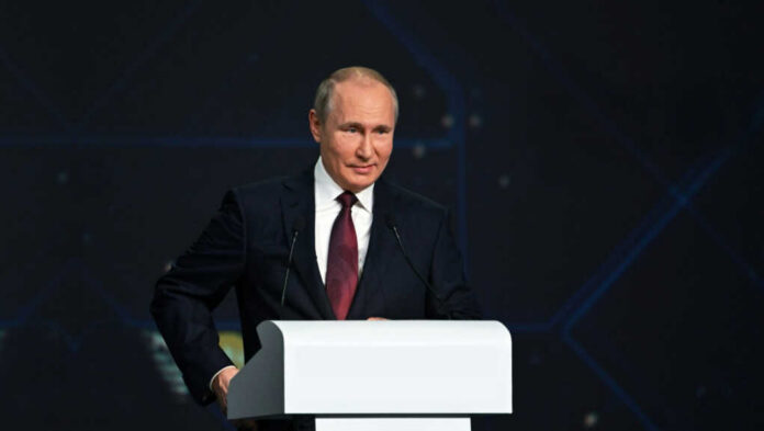 A person speaking at a podium in a suit