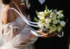 Mystery Bride Rocks Florida Politics Bride holding white flower bouquet with ribbons
