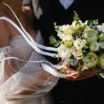 Mystery Bride Rocks Florida Politics Bride holding white flower bouquet with ribbons