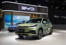 China’s EV Push Sparks Security Fears A green BYD Atto 3 electric vehicle displayed at a car exhibition