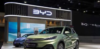 A green BYD Atto 3 electric vehicle displayed at a car exhibition