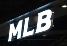 Illuminated MLB sign on a dark ceiling