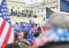 Crowd with flags near a government building