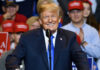 Court Smackdown Halts Trump Payout Plan smiling man in suit speaking at a rally