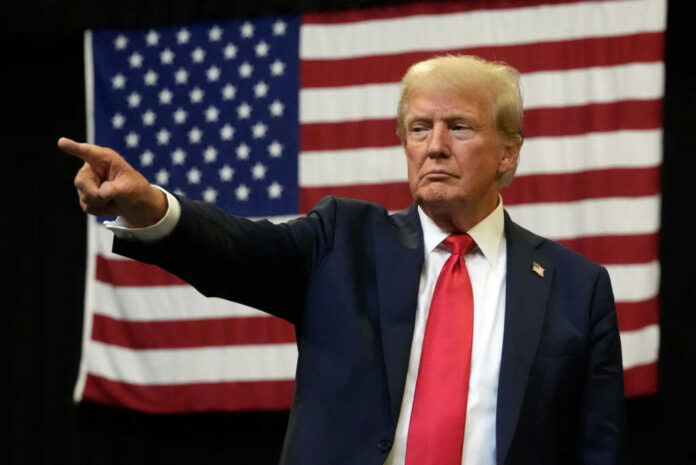 donald-trump-speaks2502402121jpg Man pointing with American flag in background