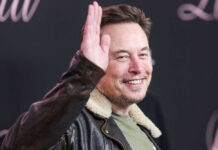 Is This Another Political Feud Over Musk? Man in leather jacket smiling and waving